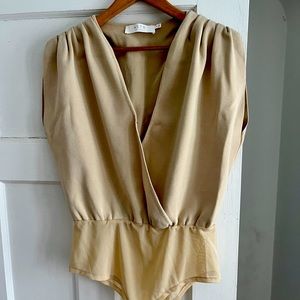 Cream short sleeve body suit. Never worn.